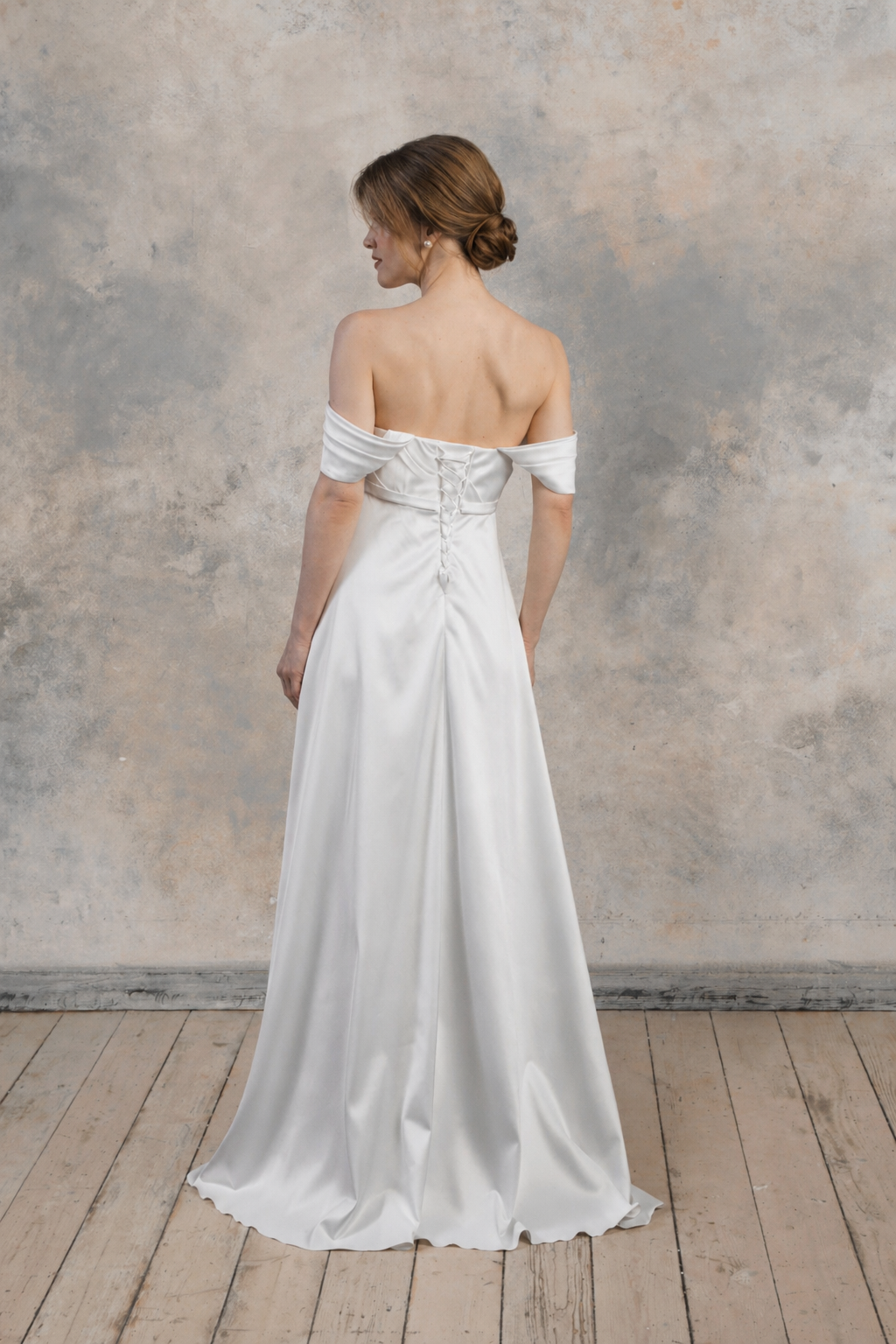 Strapless maternity gown with an open back and delicate draped detailing.