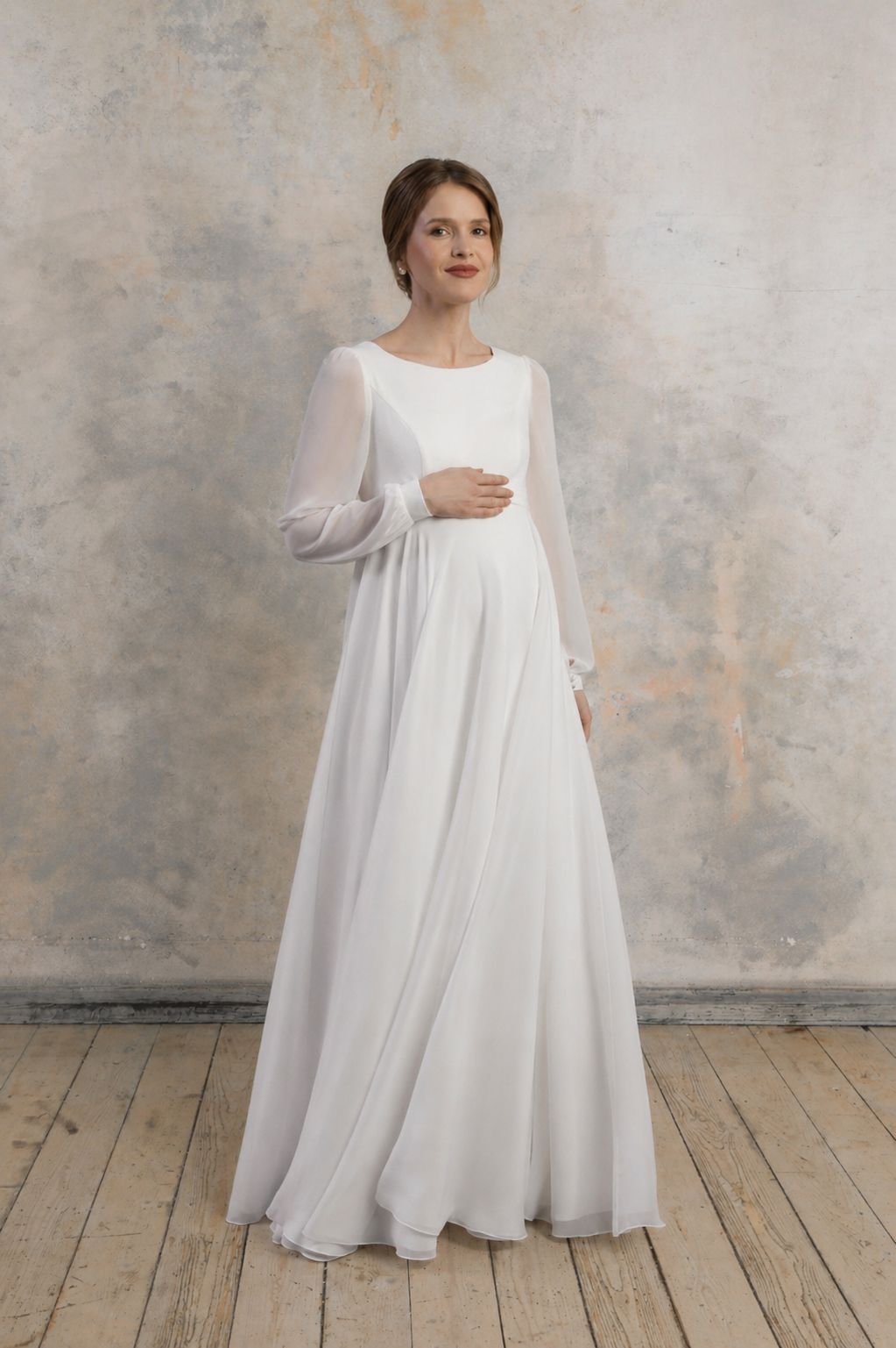 Maternity gown with long sleeves, a flowing skirt, and a relaxed, elegant silhouette.