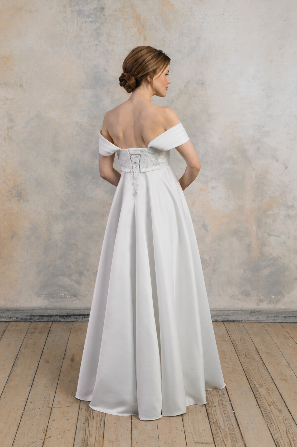 Full back view of off-the-shoulder maternity wedding dress with lace-up bodice and clean A-line skirt