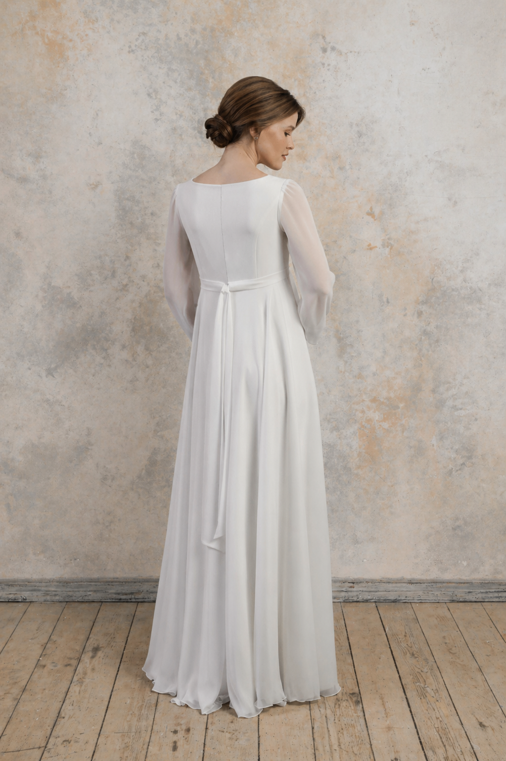 Maternity gown with long sleeves, an empire waist, and a softly flowing A-line skirt.