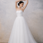 Strapless wedding gown with a structured bodice and a full flowing skirt.