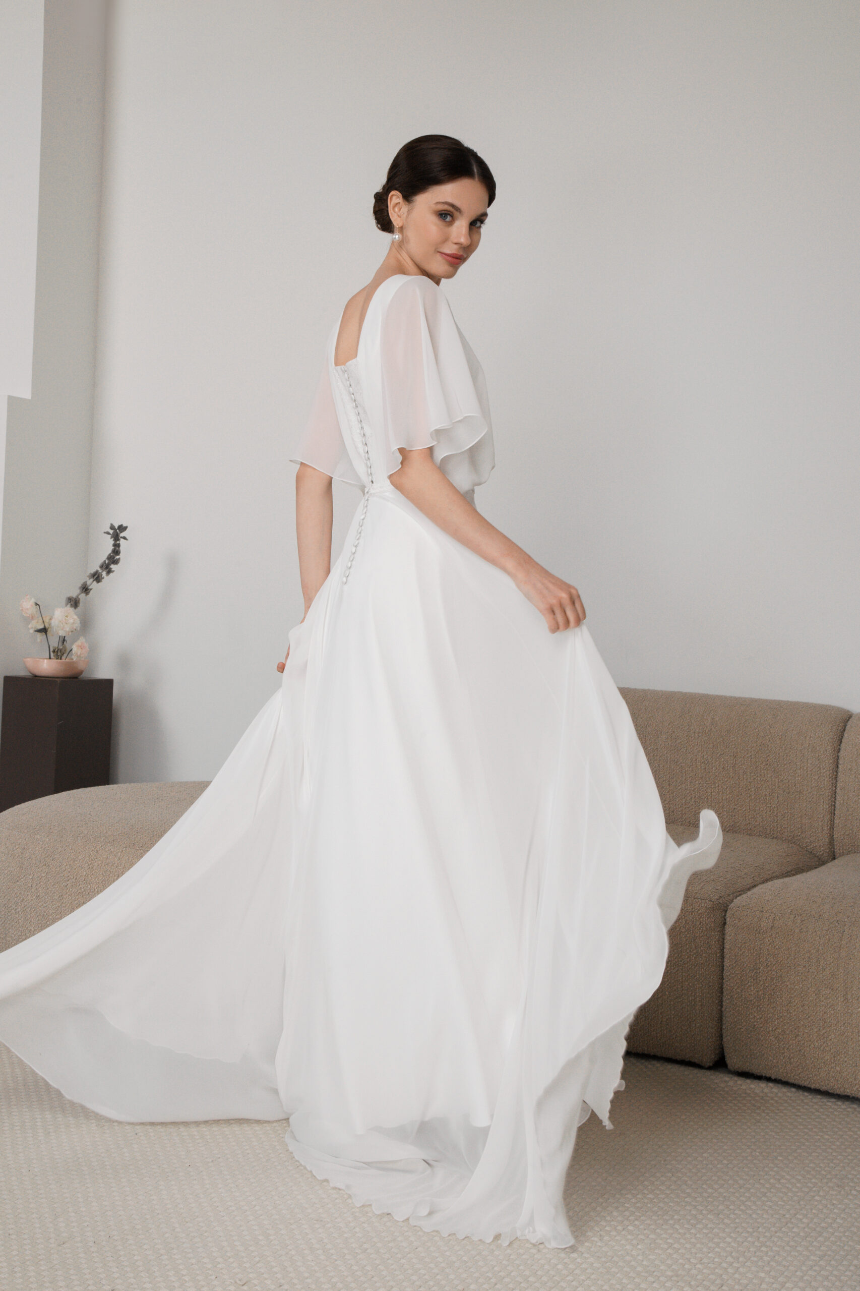 Movement shot of chiffon dress with slit and layered skirt
