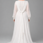 Romantic plus size wedding dress featuring a square neckline, sheer long sleeves and a flowing floor-length skirt. The soft silhouette combines comfort, elegance and timeless bridal style with a beautifully balanced shape.