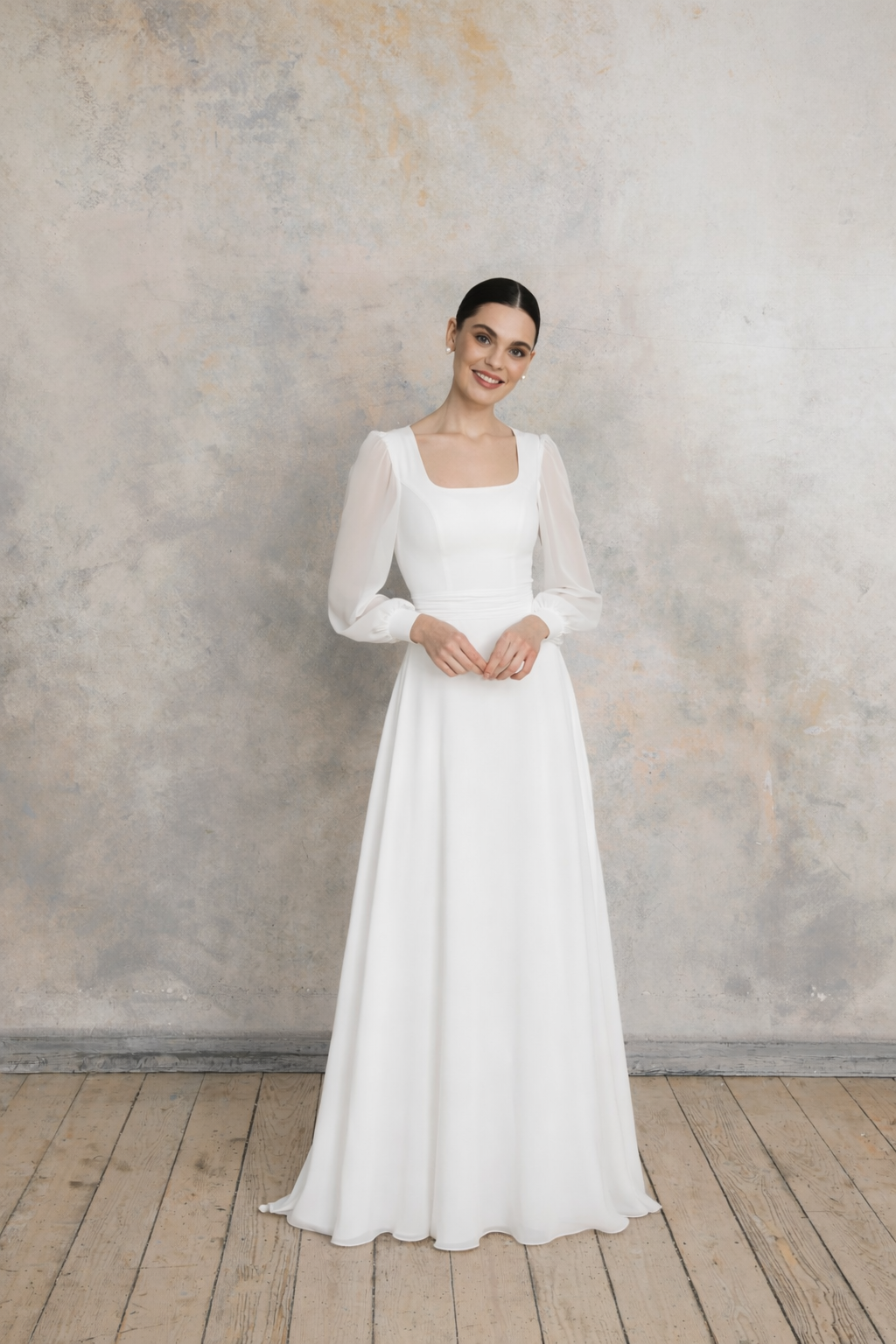 Wedding dress with square neckline, sheer long sleeves and softly flowing skirt with delicate waist shaping