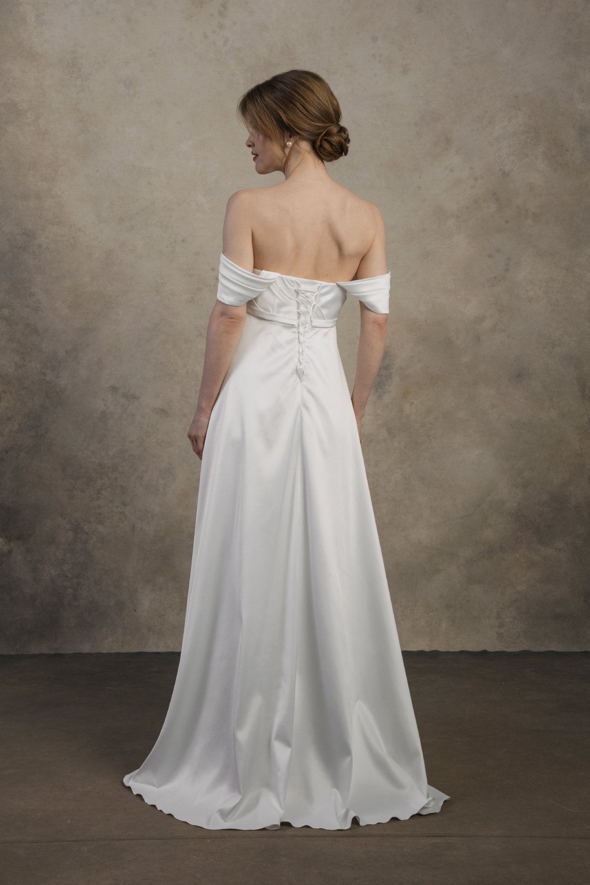 Strapless maternity gown with an open back and delicate draped detailing.