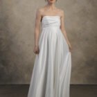 Strapless maternity gown with a flowing A-line skirt and softly structured bodice.