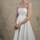Maternity gown with a strapless draped bodice and a clean flowing skirt.