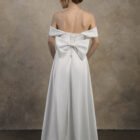 Strapless maternity gown with a removable bow and detachable train.