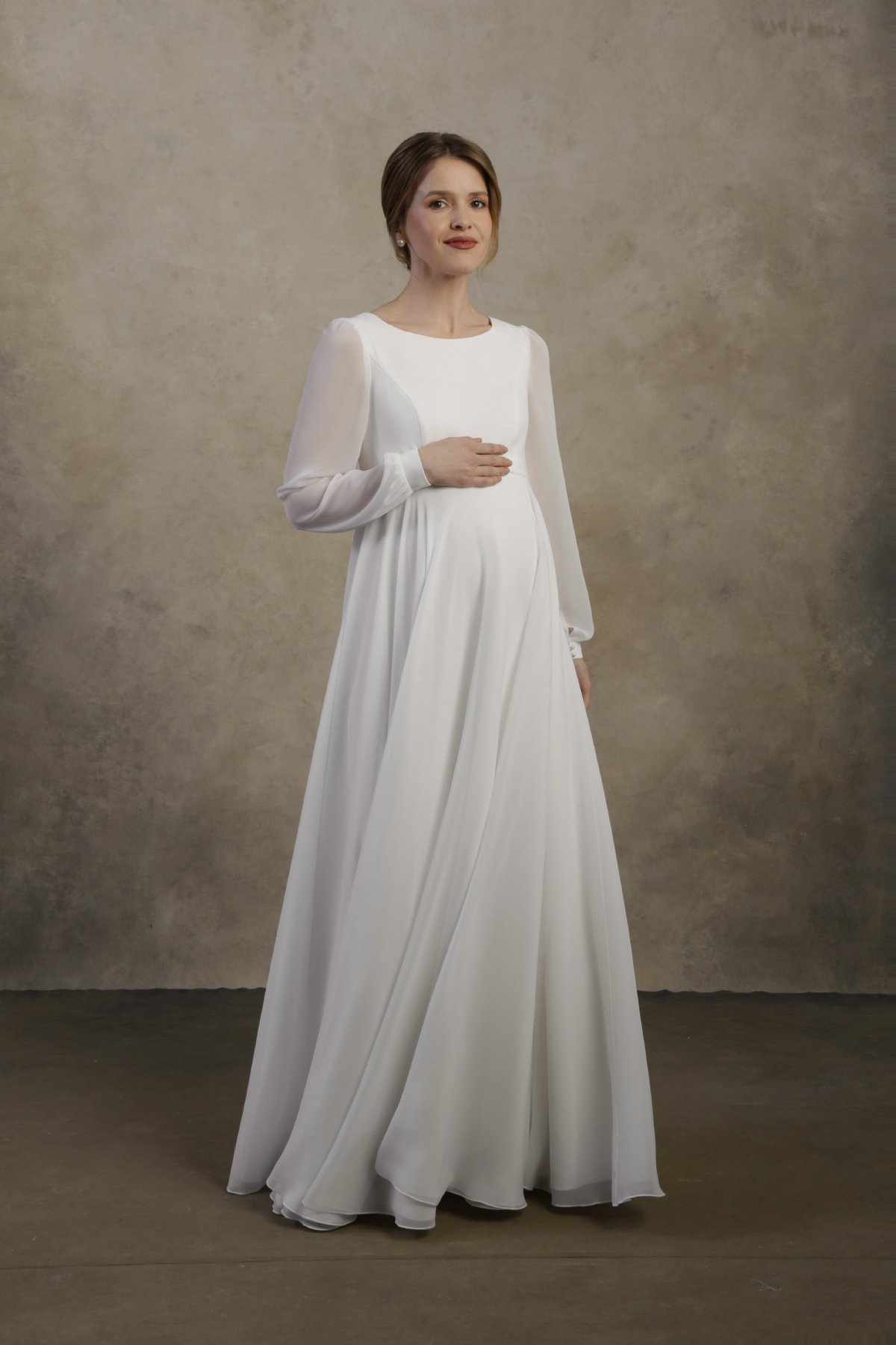 Maternity gown with long sleeves, a flowing skirt, and a relaxed, elegant silhouette.